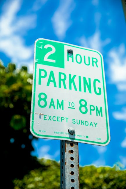 A weathered metal sign affixed to a rusted pole reads 'THIS SPACE RESERVED 24 HOURS' in white capital letters. The sign shows signs of aging, with peeling paint, rust, and corrosion, especially on the